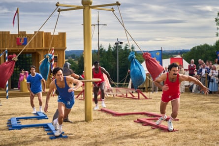 Actors from Rivals in matching outfits of red or blue singlets and short shorts running in a sports competition