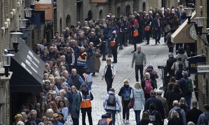 People queue near London Bridge to pay their respects to the late Queen Elizabeth II.