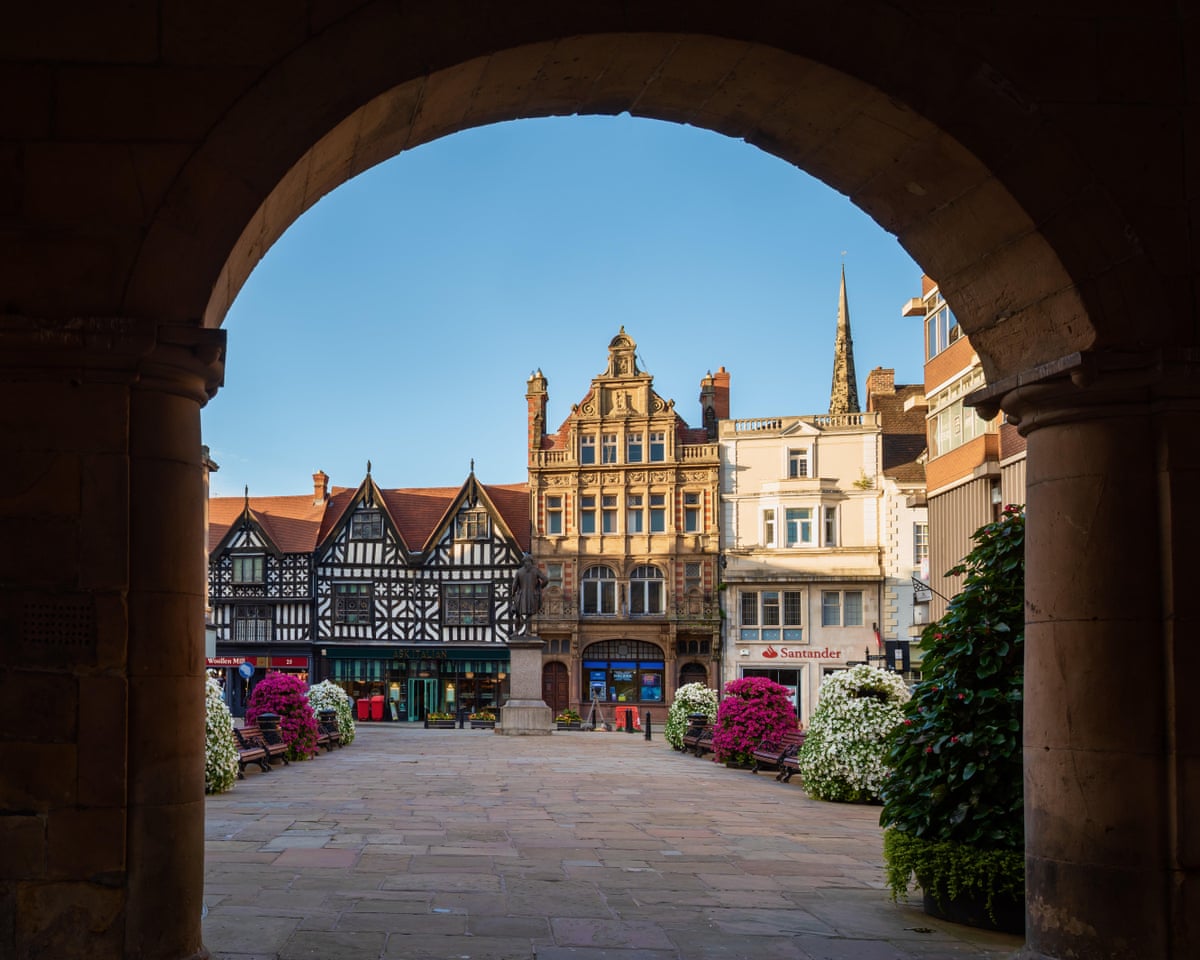 An archway looks on to Shrewsbury Square with Tudor building in the background.