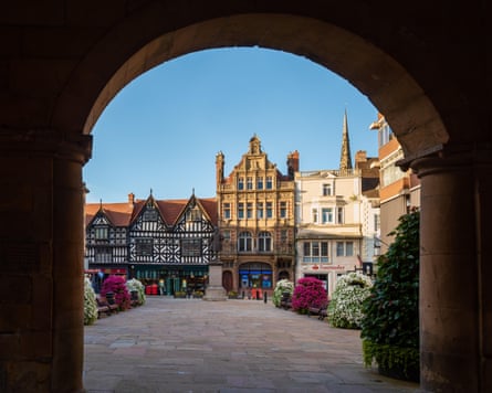 An archway looks on to Shrewsbury Square with Tudor building in the background.