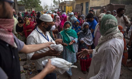 Muslims distribute food to the poor and needy in the Mustafabad area, which was recently affected by riots
