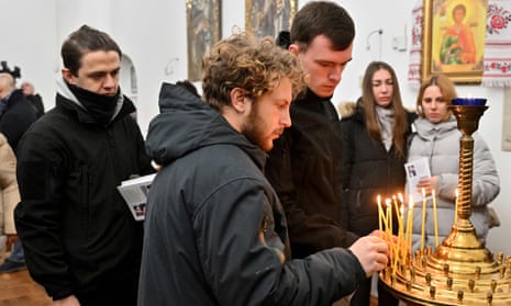 Friends and colleagues of Andrew Bagshaw set candles during the memorial service in Refectory Church of St Sophia Monastery