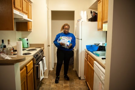 K’Acia Drummer resorts to bottled drinking water to flush her toilet, brush her teeth, cook and wash dishes at her apartment in Jackson, Mississippi on March 2, 2021.