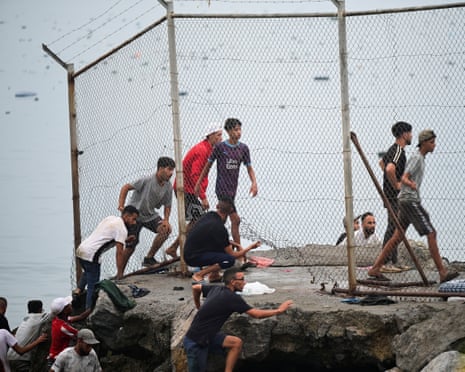 Migrants return back to Morocco, as seen from Ceuta, Spain.