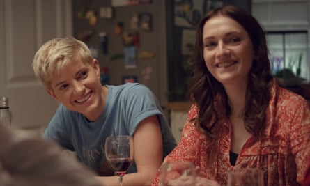 Mae Martin and Charlotte Ritchie sitting at a dinner table, smiling