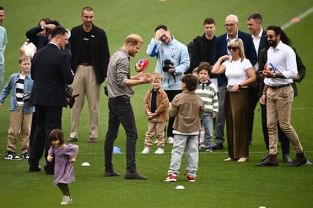 Prince Harry with crowd on football oval