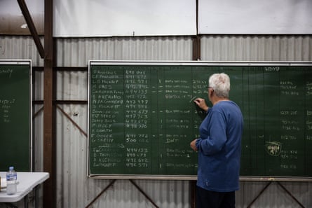 One of the Blacktown racing clubs patrons marking up a score board.