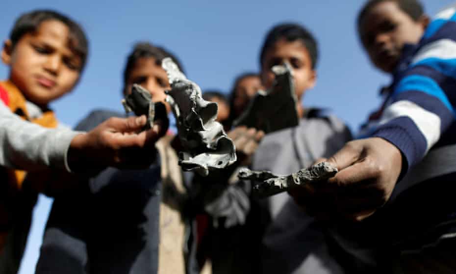 Boys hold missile shrapnel they collected from the site of a Saudi-led air strike in Sanaa, Yemen. Canberra-made weapons are being sold to Saudi Arabia. 