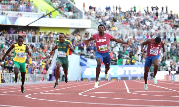 Fred Kerley stretching his arms to lead his American teammates to the 100m gold medal