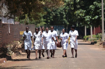 A group of nurses walk in the grounds of Parirenyatwa hospital in Harare, Zimbabwe, 2019