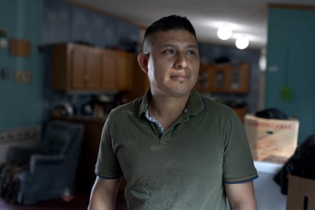 A man in a green shirt in his home.