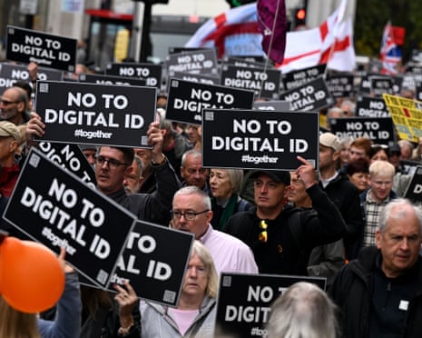 Demonstrators hold 'No to digital ID' placards during a central London march in October 2025