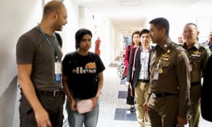 Saudi woman Rahaf Mohammed al-Qanun (second left) is escorted by a Thai immigration officer and UNHCR officials at the Suvarnabhumi international airport in Bangkok on Monday.