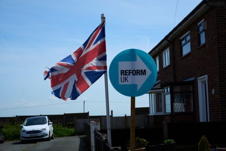 Reform UK party placards and union flags in Ashton-in-Makerfield