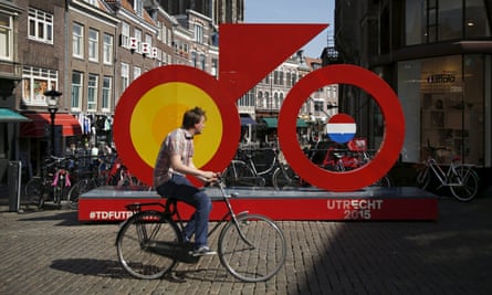 A man rides past the Grand Depart logo for the 2015 Tour de France in Utrecht.