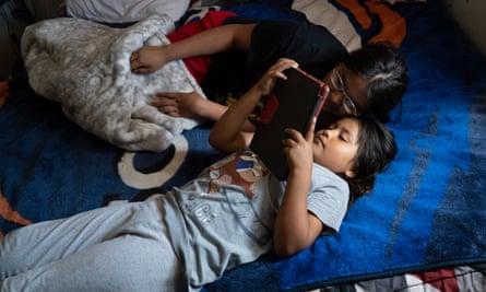 Tammie and Clifton Mariano’s children play video games on an iPad at the family home in Shiprock.