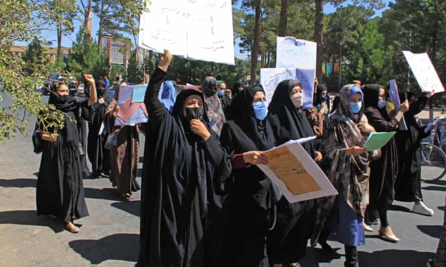 Afghan women hold posters during protest in Herat