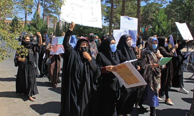 Afghan women hold placards at protest in Herat