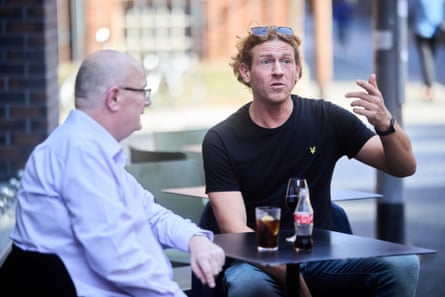 Matt and Sam chatting at a restaurant table outside