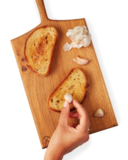 Meanwhile, grill or toast the bread, then rub it with the remaining half-clove of raw garlic and drizzle with oil.