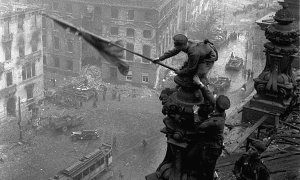 Soviet soldiers hoist the red flag over the Reichstag in May 1945