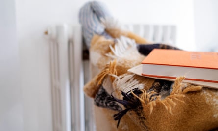 Feet of someone wearing warm clothes resting on a radiator