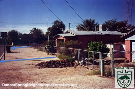 An old photo shows Dunbar Spring in the 90s.  The blue arrows indicate the storm water runoff flowing onto the street.
