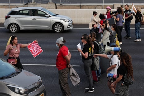 People attempt to block traffic during a protest on the main highway connecting Jerusalem and Tel Aviv, 2 May.