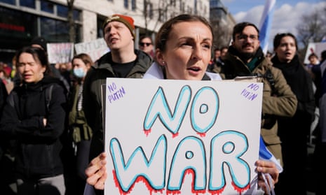 A woman holding a sign that reads 'No war, no Putin’.