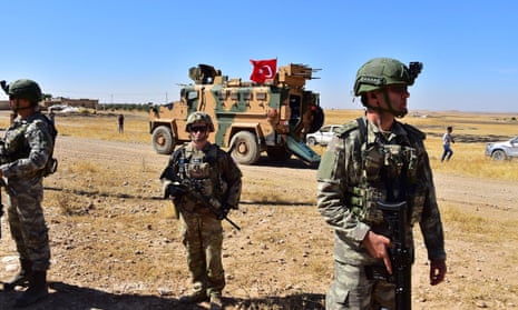Turkish and US soldiers patrol together in Northern Syria, in Tal Abyad, near Turkey border in Syria. 