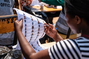 A woman checks names on the electoral register