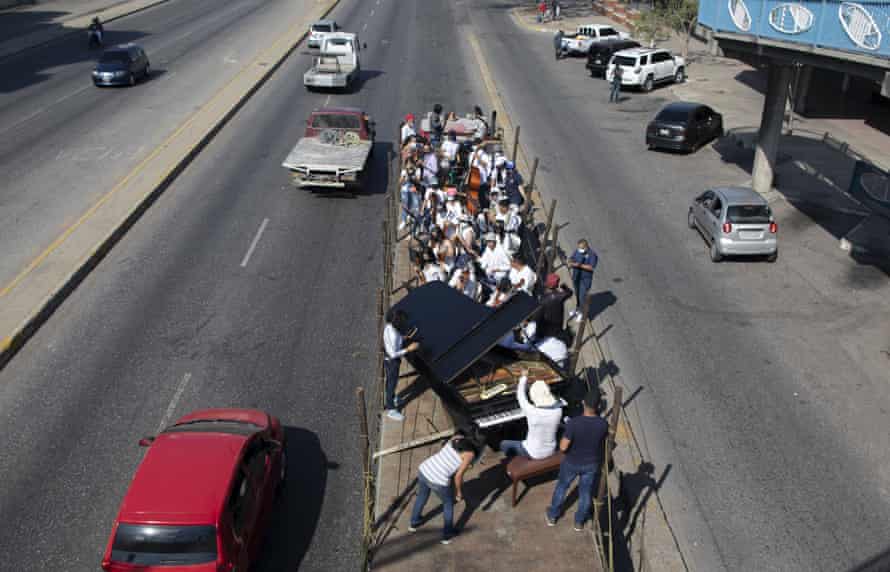 Agency photographer of the year – 2021 shortlist | World news 22 Musicians join pianist, composer and conductor Jose Agustin Sanchez on the bed of an 18-wheeler truck for a musical tour coined a “musical disinfection” in Barquisimeto, Venezuela, Thursday, March 4, 2021. Sanchez, who last year started playing what he calls his “Musical Vaccine” for COVID patients, is now joined by other musicians as they ride through the city playing his original compositions for anybody that wants to listen
