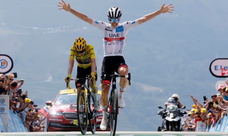 Tadej Pogacar celebrates as he crosses the finish line to win stage 17.