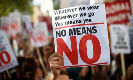 A woman holds a banner in London during a rally calling for improved justice for rape victims.