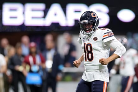 Caleb Williams clenches his fists, shouting in celebration after a touchdown