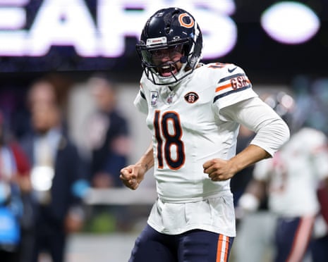 Caleb Williams clenches his fists, shouting as he celebrates a touchdown