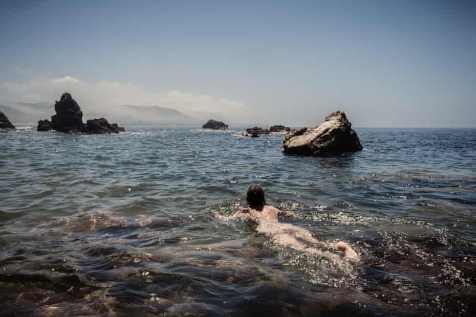Jade Lotus from London swims naked in the sea near Praia do Amado, Portugal.