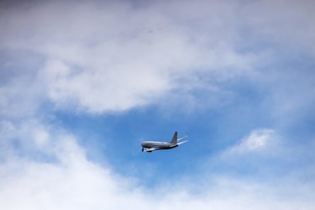 plane in blue sky on partly cloudy day