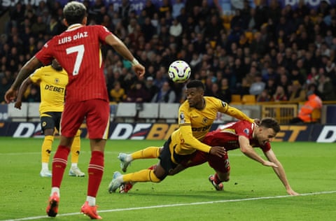 Wolverhampton Wanderers' Nelson Semedo concedes a penalty against Liverpool's Diogo Jota.