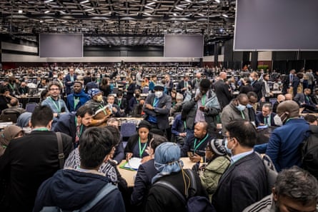 Delegates confer over the final text at COP15 on Monday.