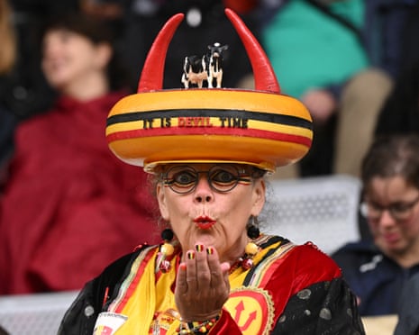 A Belgium supporter with a round of cheese on her head