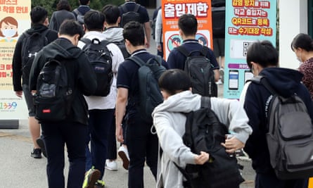 High school students arrive at a high school in Seoul