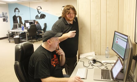 Garland Couch (seated) works on some code with James Johnson (standing)