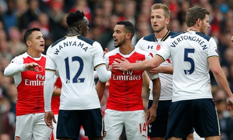 Arsenal’s Theo Walcott clashes with Tottenham’s Victor Wanyama.