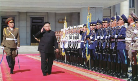 a man walking in front of other men in military uniforms