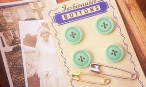Close up of pale green buttons on card with safety-pins circa 1920.