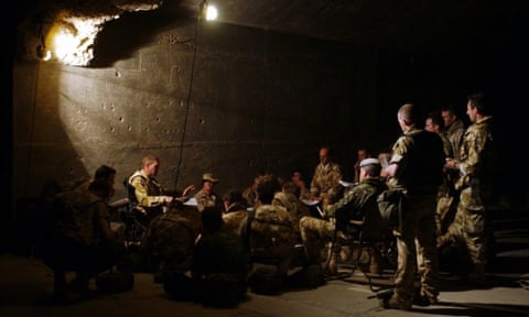 Members of the British Royal Scots Dragoon Guards gather to prepare their battle plans near Basra in Iraq