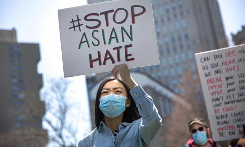 A woman holds a placard as she participates in a Stop Asian Hate rally at Columbus Park in New York City last year.