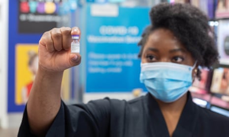 Siphiwe Chungu, pharmacist manager at a chemist in Leeds with a vial of Pfizer which will be administered as the first high street Covid booster vaccination in the UK. 