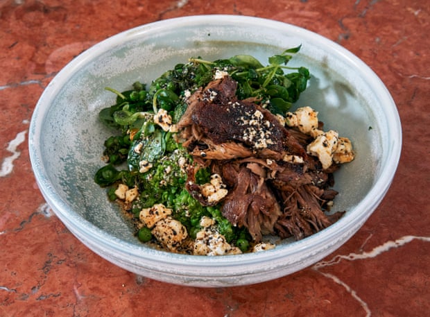 ‘Vitamin-powered goodness’: Honey & Co’s crisped lamb shoulder, crushed fresh peas, rocket and mint, feta, and urfa butter dressing.